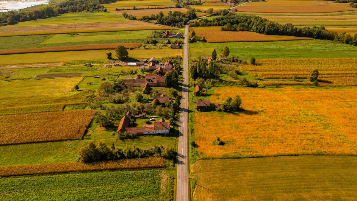 Scenic aerial view of rural landscape with fields and a country road in Garešnica, Croatia during autumn.